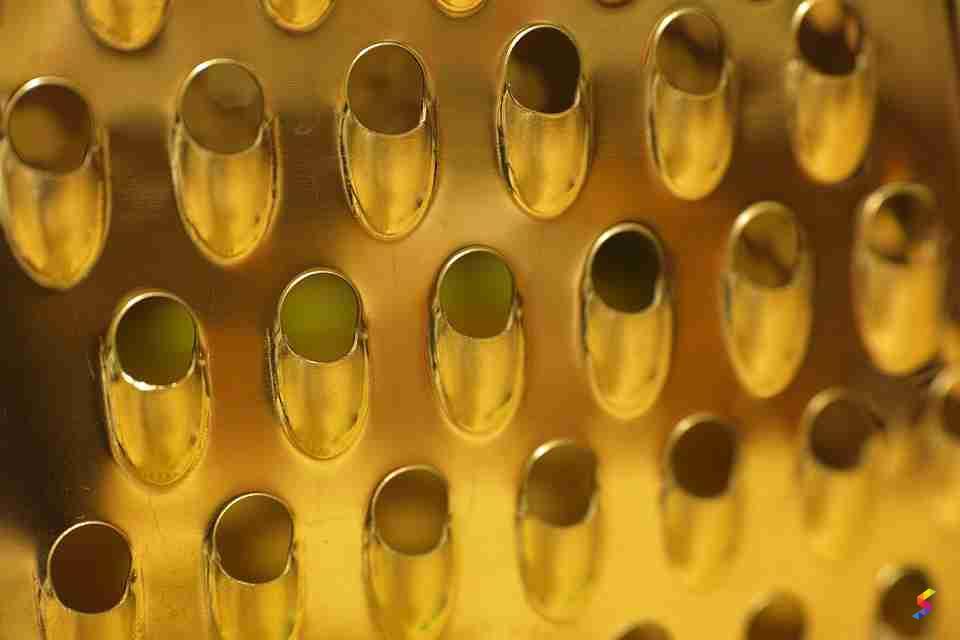 Define Grating, Grating Meaning, Grating Examples, Grating Synonyms